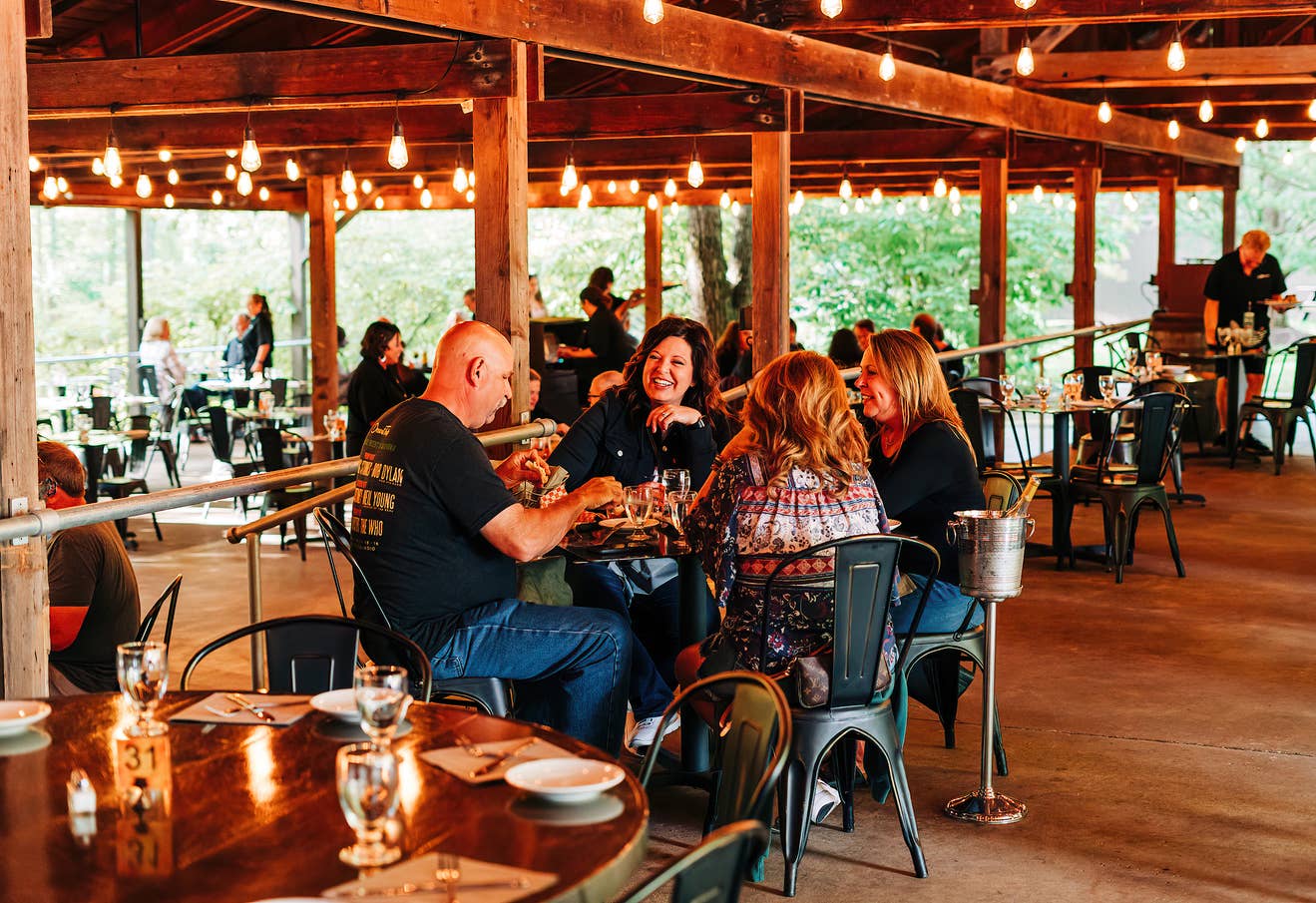 A table of fans laughing over a meal in the Blossom Grille.